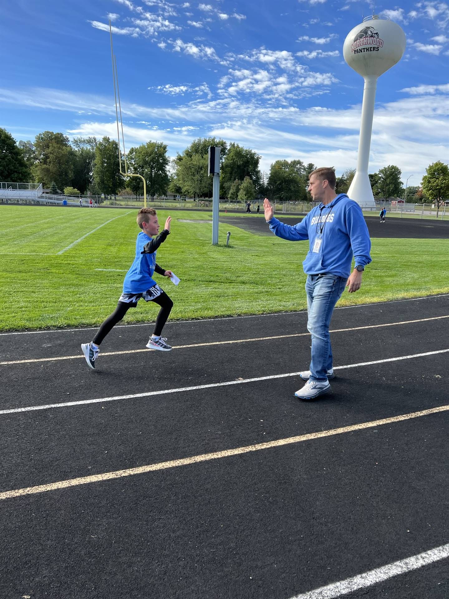 runner high fiving Mr. Cripe