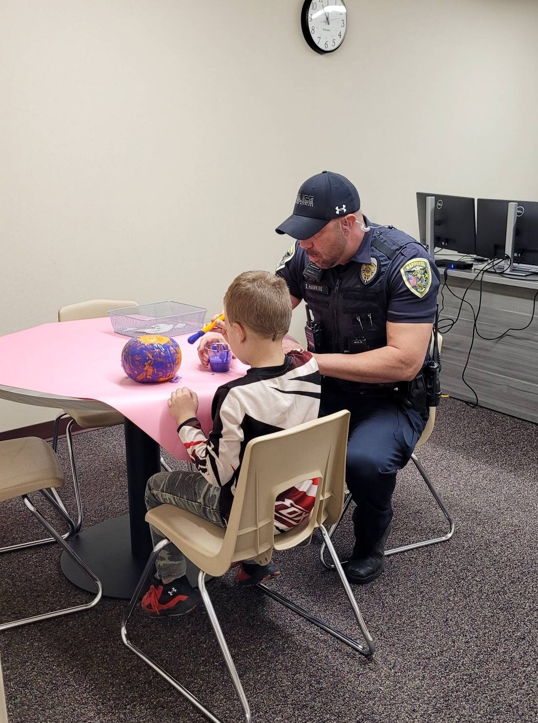 Officer Hawkins helping student